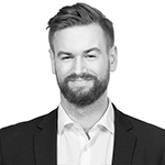 A black and white photo of a man with a beard.